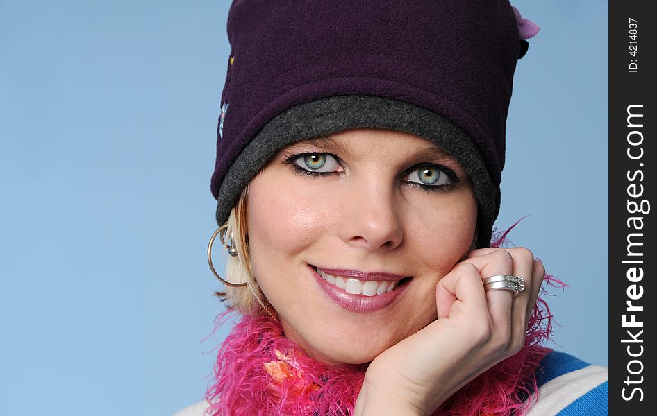 Portrait of winter girl smiling isolated on blue