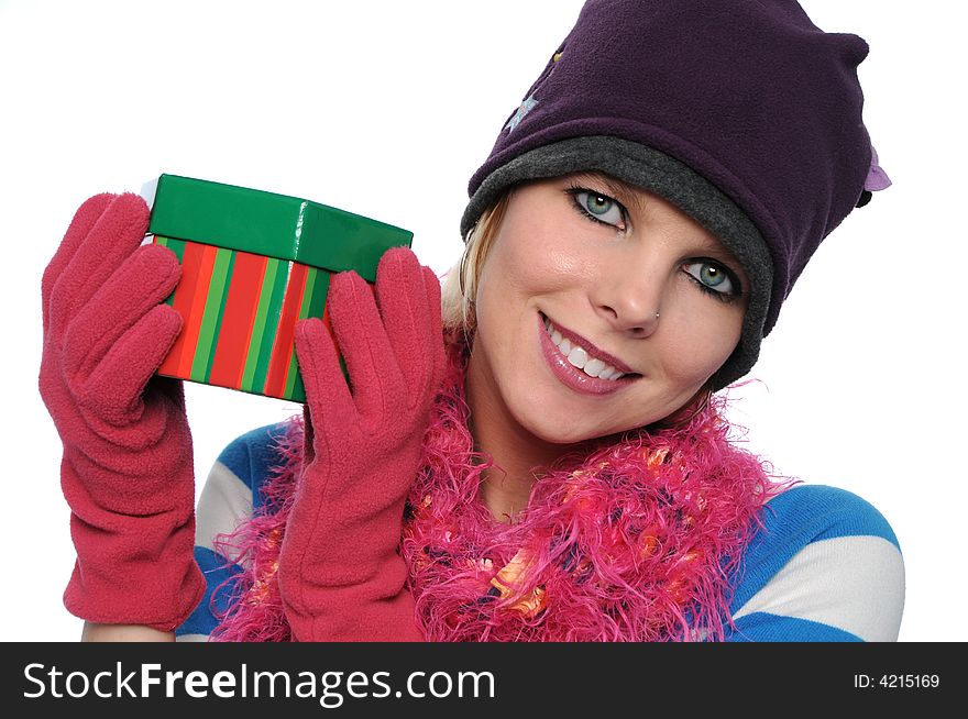 Gorgeous girl holding gift with winter clothes isolated on white