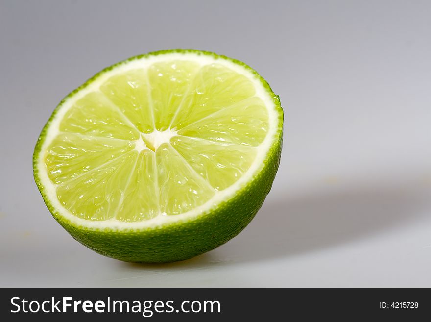 Half green lime, isolated on white background. Half green lime, isolated on white background