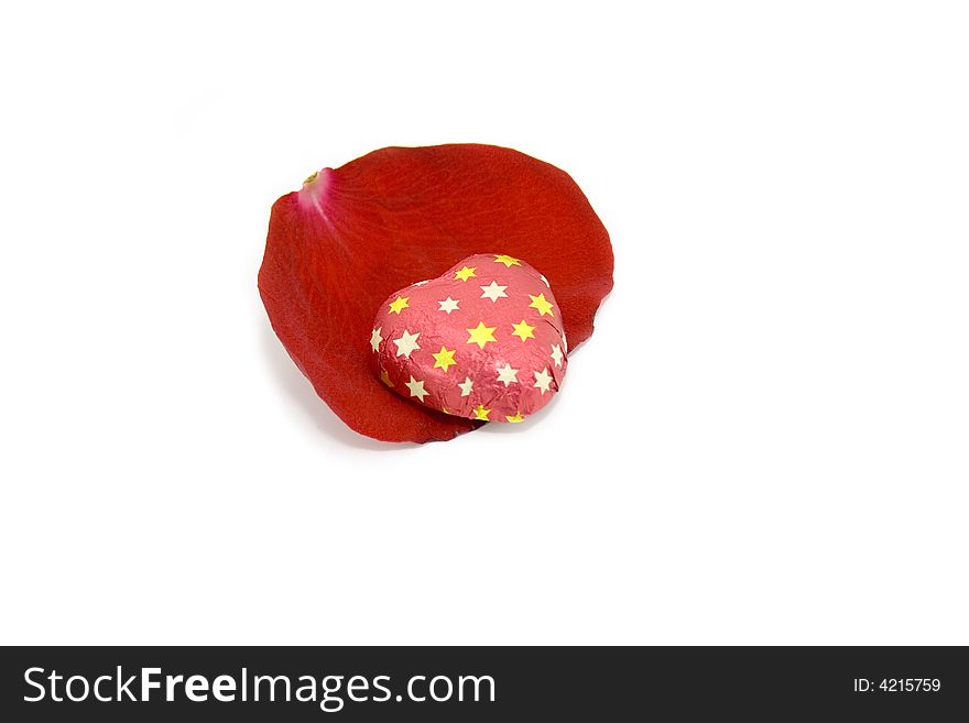 Chocolate sweet over the rose petal.