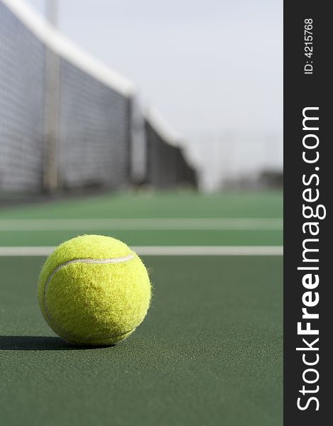 A picture of a tennis ball on the court. A picture of a tennis ball on the court