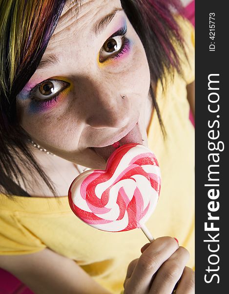 Close-up of an Alternative Girl with a Heart Lollipop