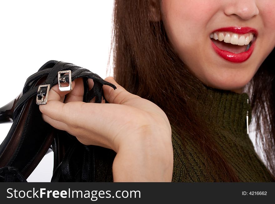 Girl wearing a red lipstick and holding her shoes. Girl wearing a red lipstick and holding her shoes