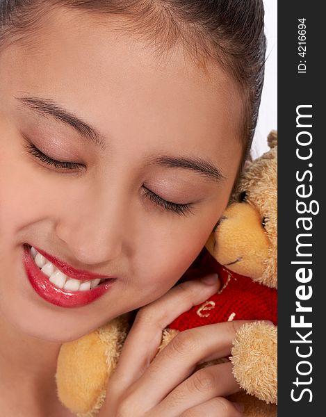 Lovely girl cuddling her teddy bear - smiling