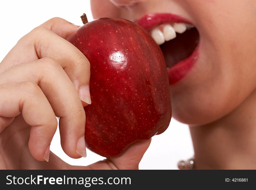 Young girl heaving a bite on a delicious and tasty red apple. Young girl heaving a bite on a delicious and tasty red apple