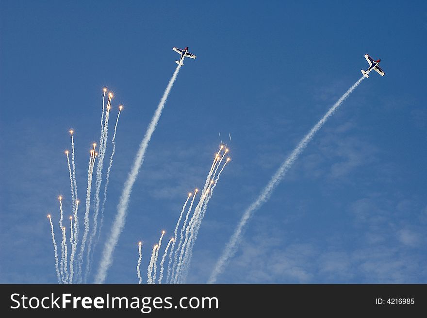 Two plane drop a fireworks display during their maneuver at the Al Ain Aerobatic Show. Two plane drop a fireworks display during their maneuver at the Al Ain Aerobatic Show.