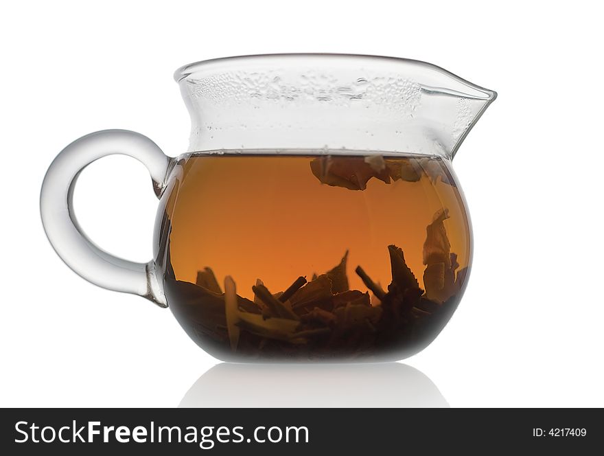 Glass teapot with tea on white background