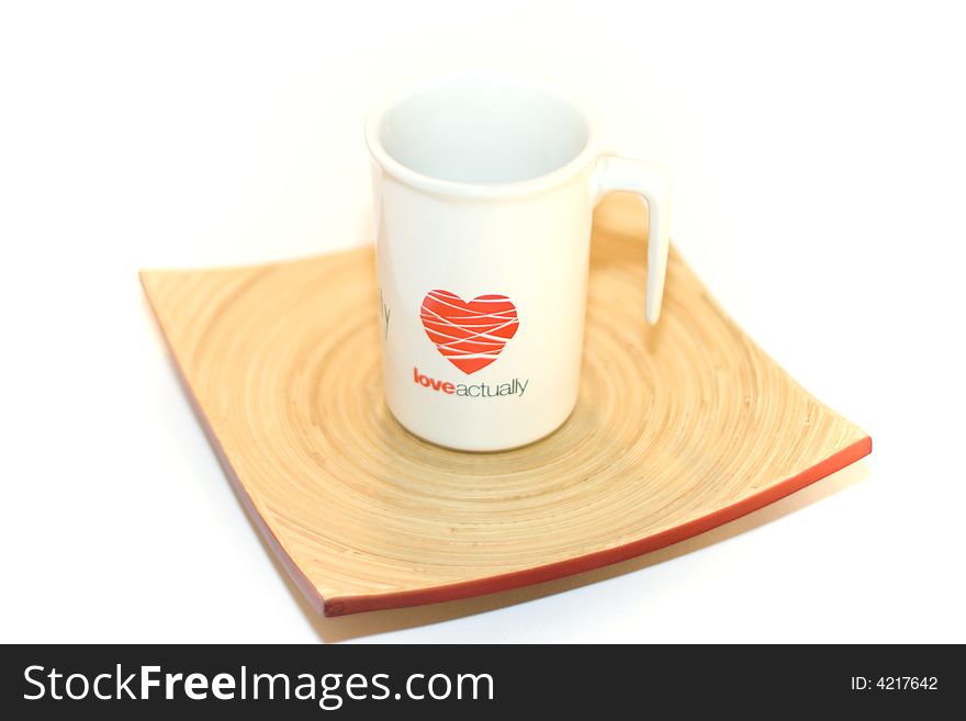 White cup love actually on the plate isolated
