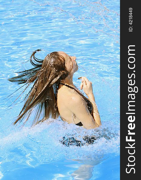 Woman takes a bath in the swimming pool. Woman takes a bath in the swimming pool