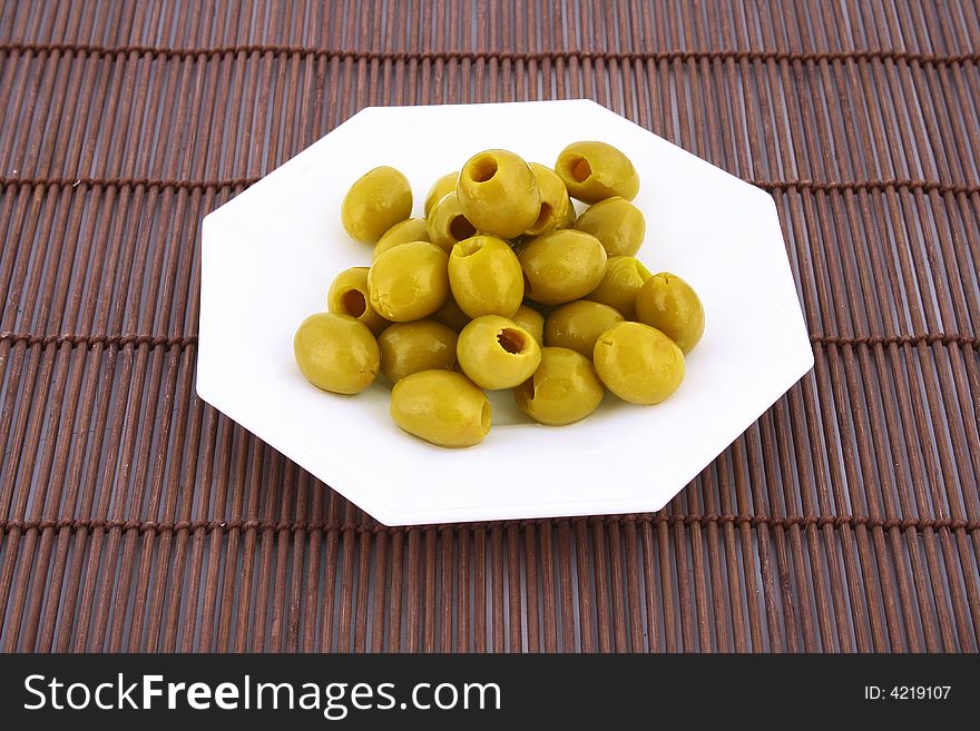 A small bowl of olives on a table