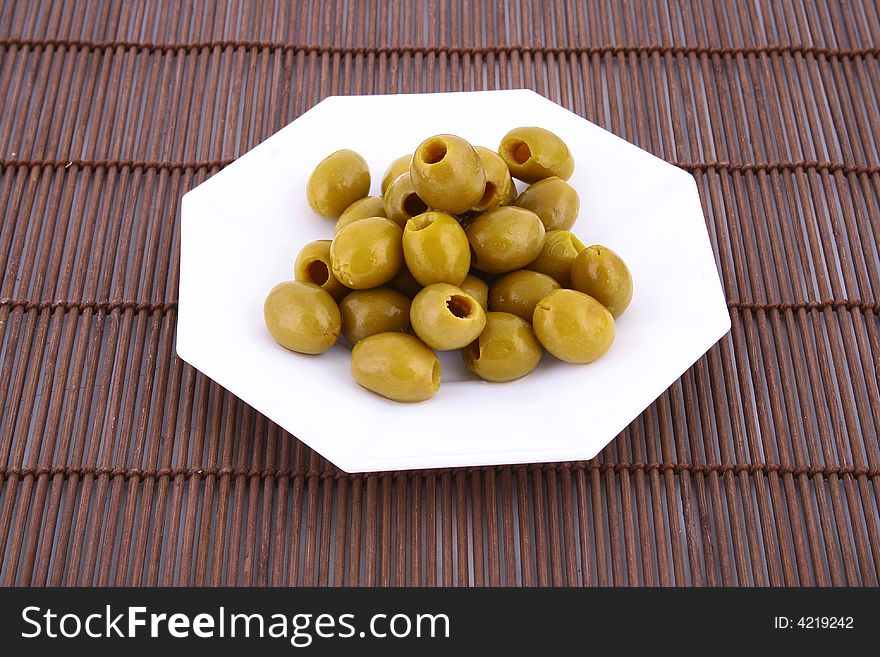 A small bowl of olives on a table