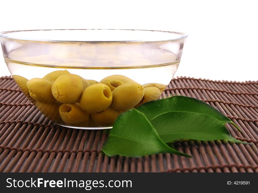 A small bowl of olives on a table
