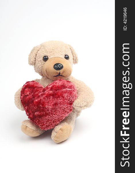 Teddy bear with red heart on white