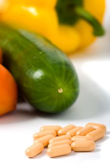 Closeup Pills With Vegetables Royalty Free Stock Image