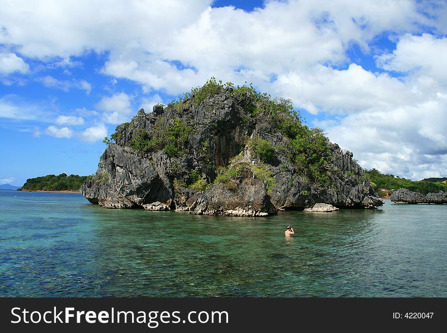 Scenic view of a tropical island in a lagoon. Scenic view of a tropical island in a lagoon