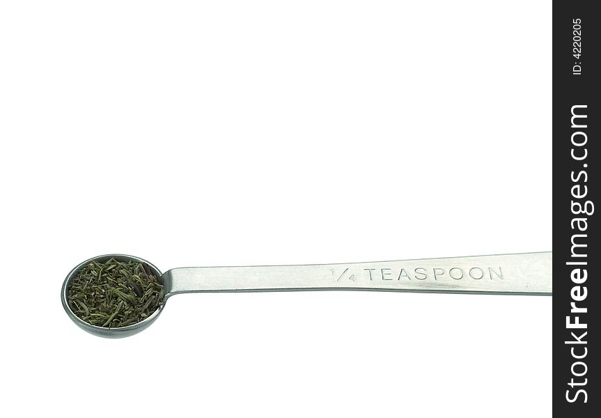 Oregano in a quarter-teaspoon. Isolated on white background with clipping path.