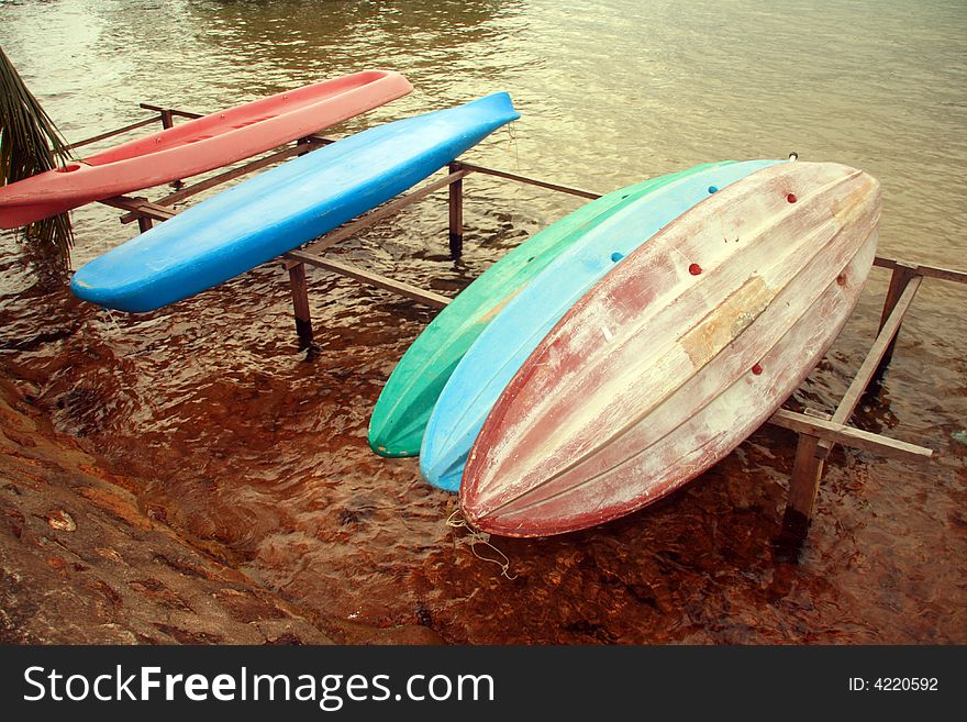 A bunch of plastic canoes for rent on a nearby beach resort