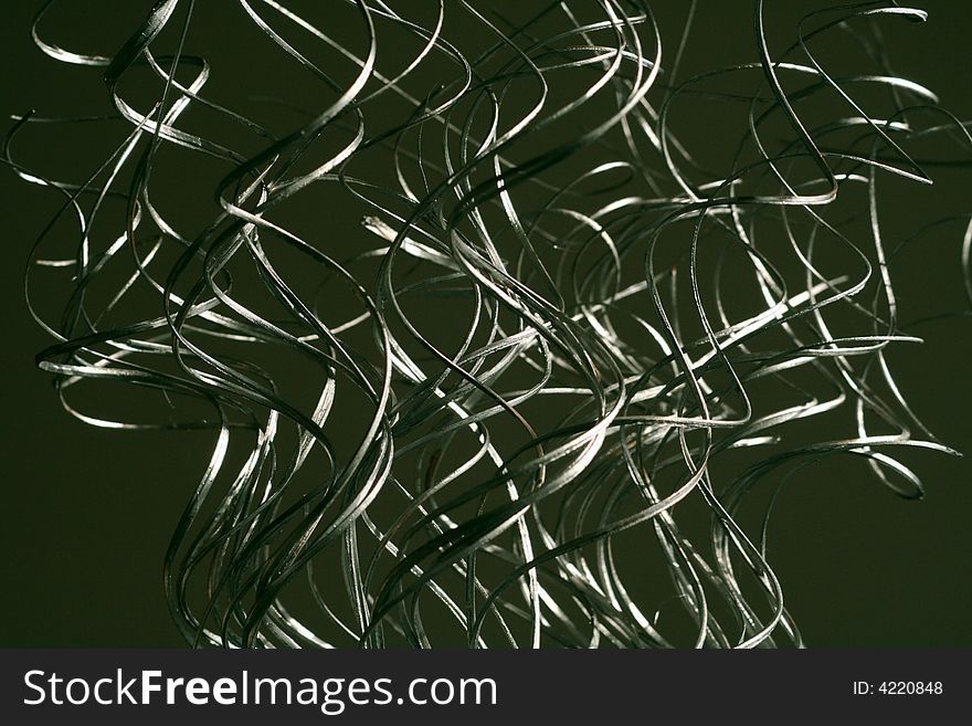 Silver swirling grass like decorations arranged in a vertical fashion. Silver swirling grass like decorations arranged in a vertical fashion.
