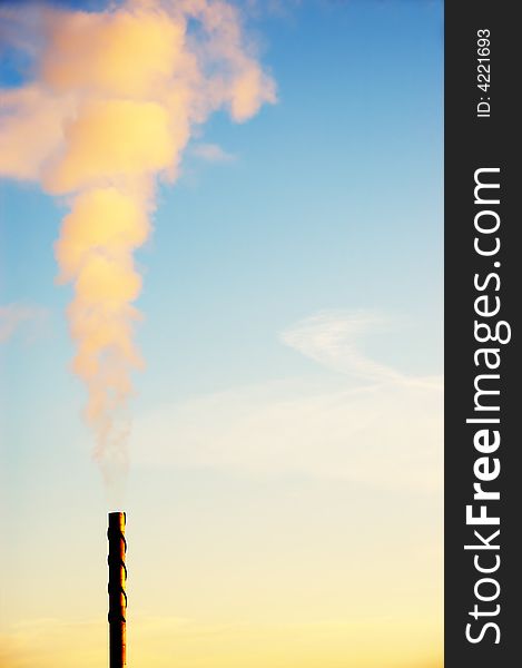 A Factory chimney at sunrise