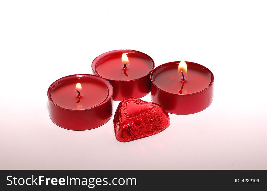 Three candles and valentine candy