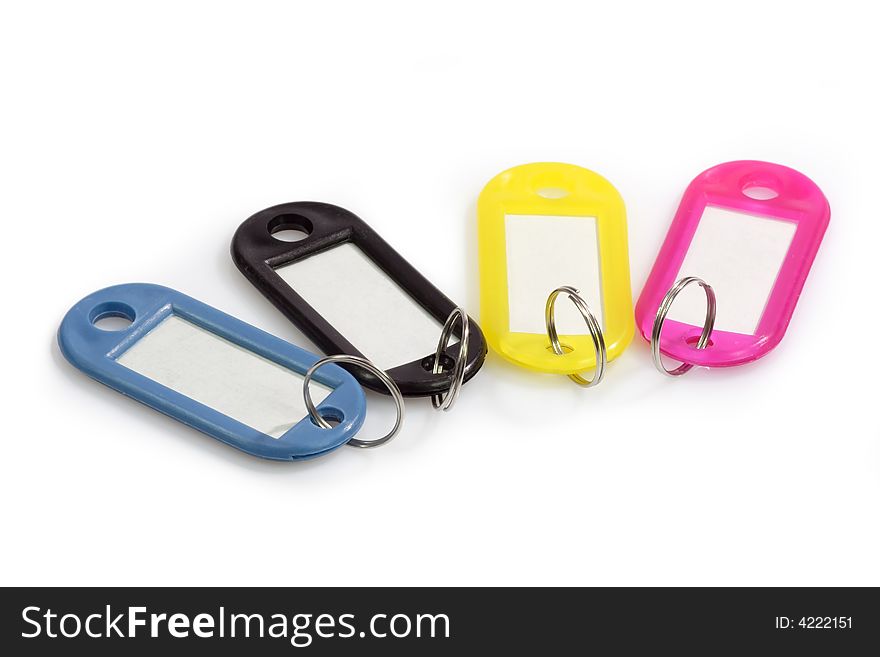 Colorful blank key fobs on bright background.