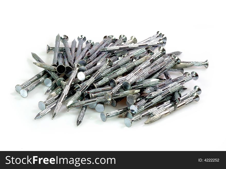 Pile of metal nails on bright Backkground