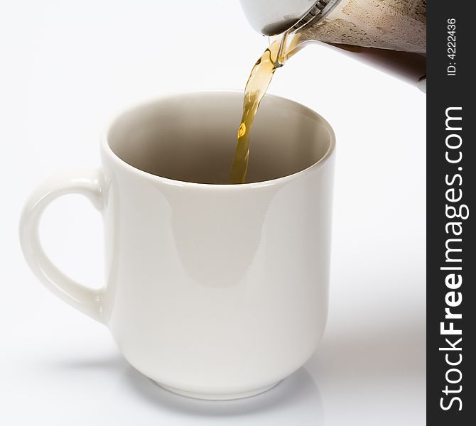 French press made coffe being poured into coffe cup. French press made coffe being poured into coffe cup