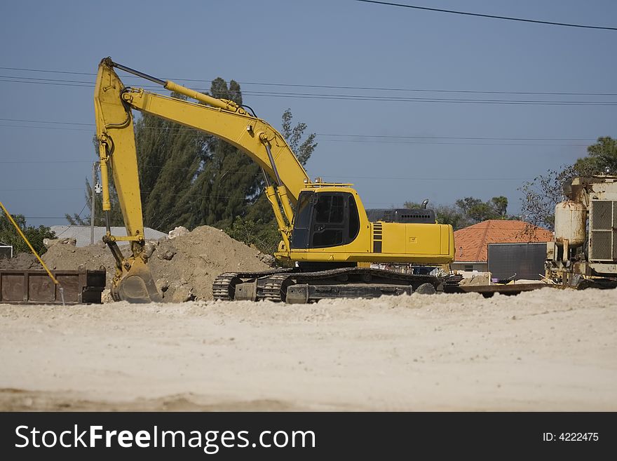 A backhoe sits Idle during the lunch break. A backhoe sits Idle during the lunch break