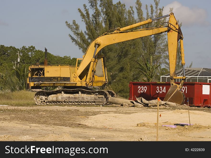 A backhoe sits idle during a lunch break at this construction site. A backhoe sits idle during a lunch break at this construction site