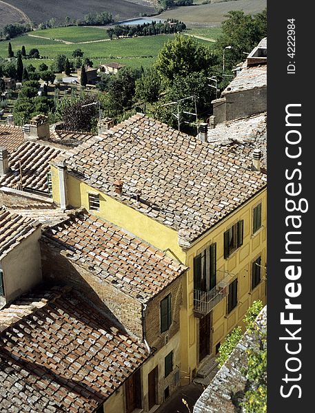 Cortona rooftops with field at the background, Italy