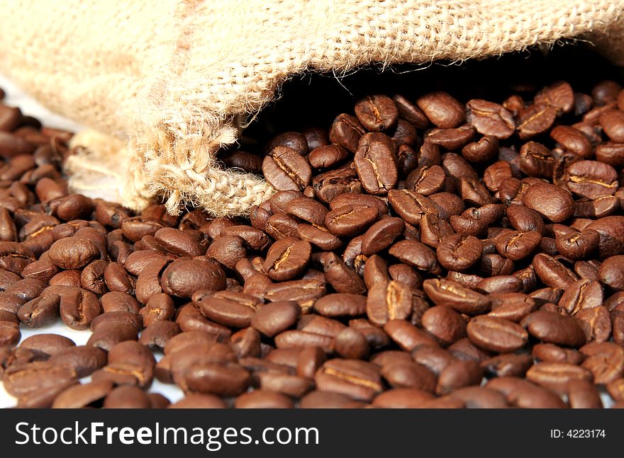 Brown, aromatic coffee beans in a gunnysack. Brown, aromatic coffee beans in a gunnysack
