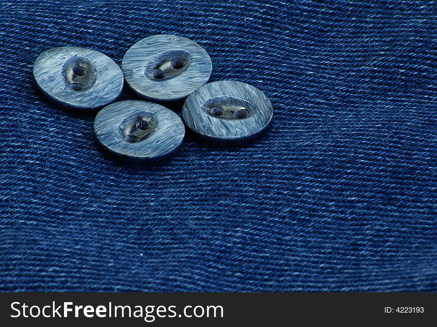 Decorative buttons on dark blue denim jean material. Decorative buttons on dark blue denim jean material