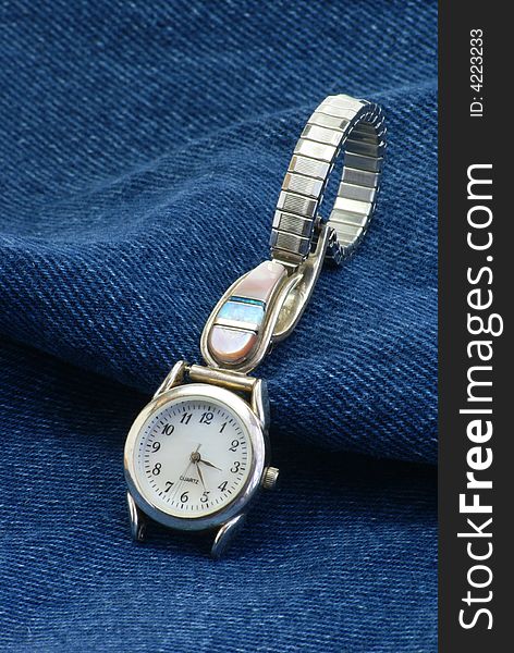 Ladies jewelry wrist watch on dark blue denim fabric. Ladies jewelry wrist watch on dark blue denim fabric.