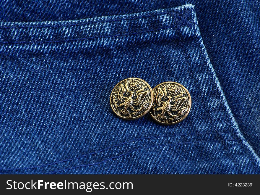 Decorative buttons on dark blue denim jean material. Decorative buttons on dark blue denim jean material