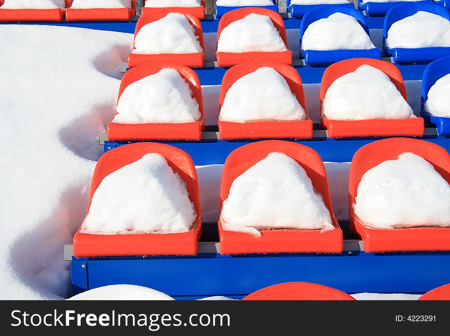 Seats on tribunes of stadium under a snow. Seats on tribunes of stadium under a snow