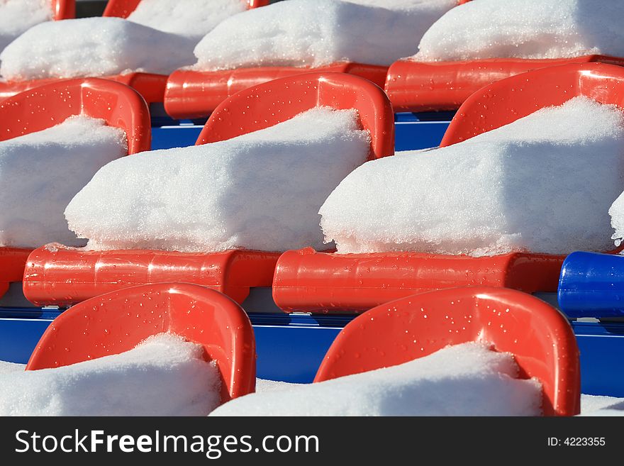 Seats on tribunes of stadium under a snow. Seats on tribunes of stadium under a snow