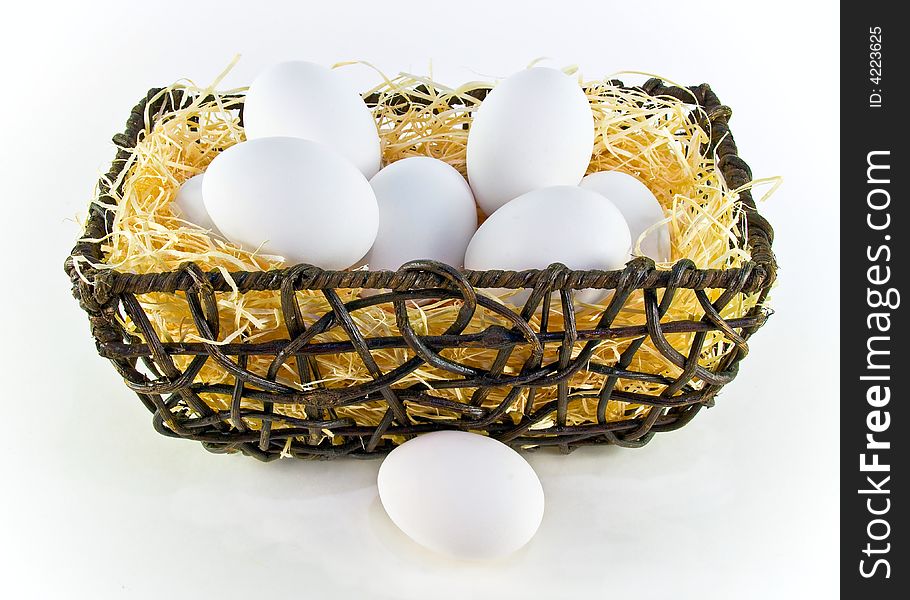 White eggs in a basket over white