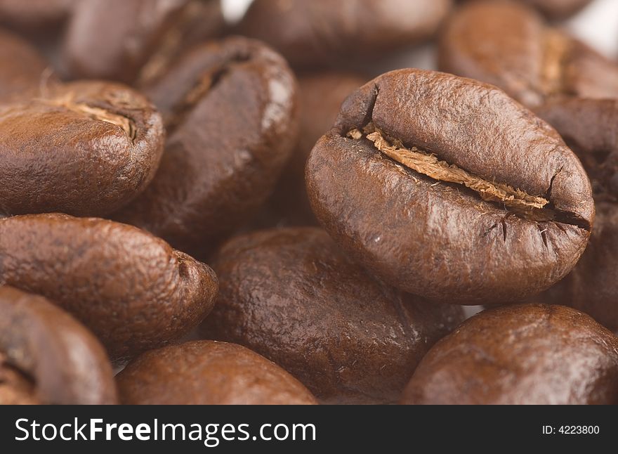 Several brown Coffeebeans up close.