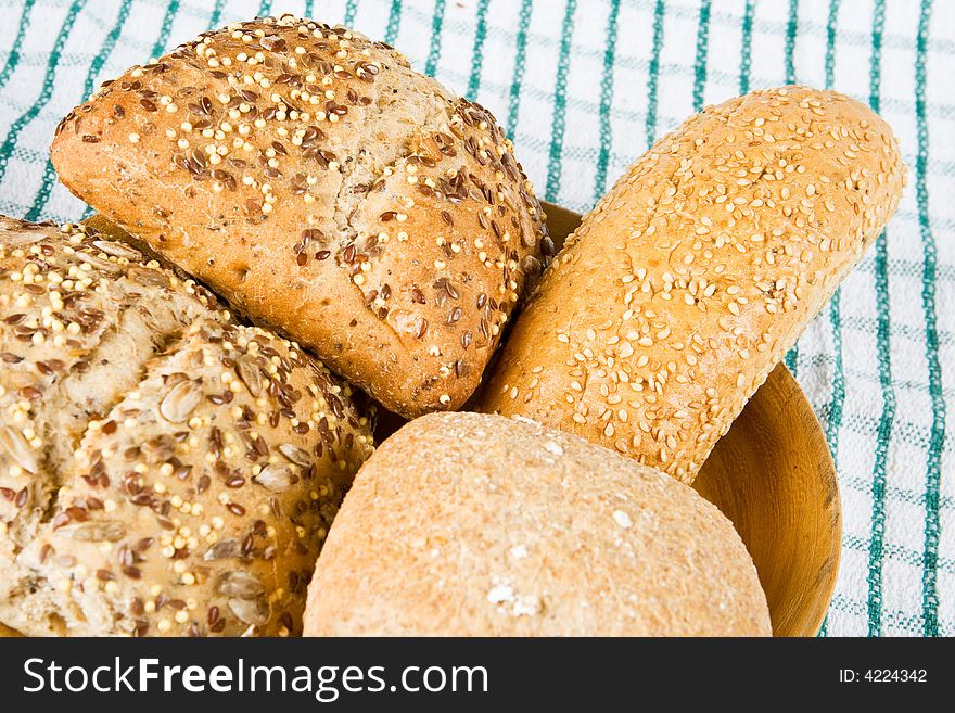 Mixed bread buns in a wooden bowl