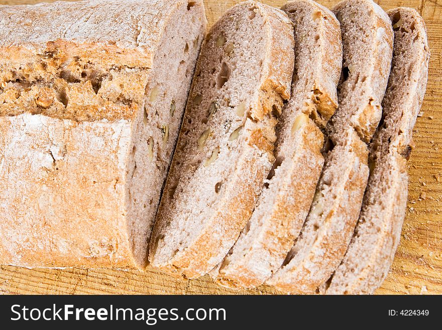Freshly cooked walnut bread on a wooden background