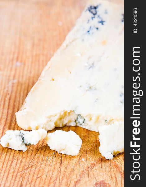 Fresh blue stilton cheese with focus on the broken chunks. Fresh blue stilton cheese with focus on the broken chunks