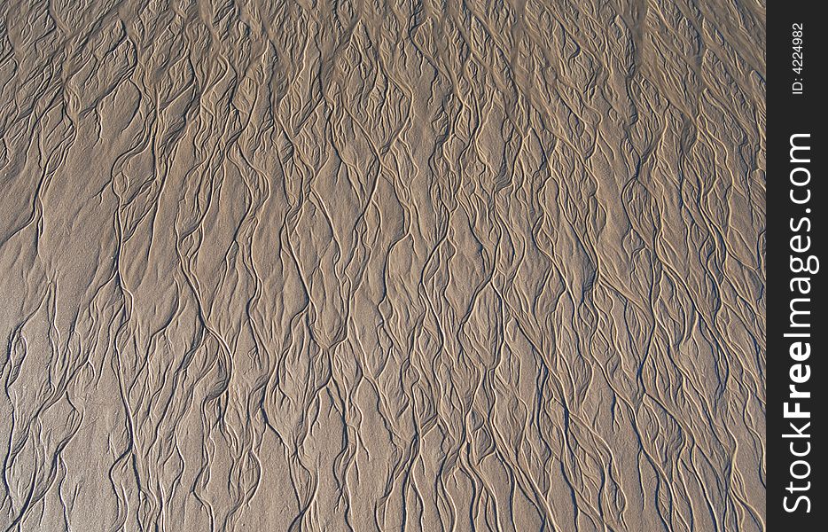 Low tide on a Portuguese beach, sand patterns.