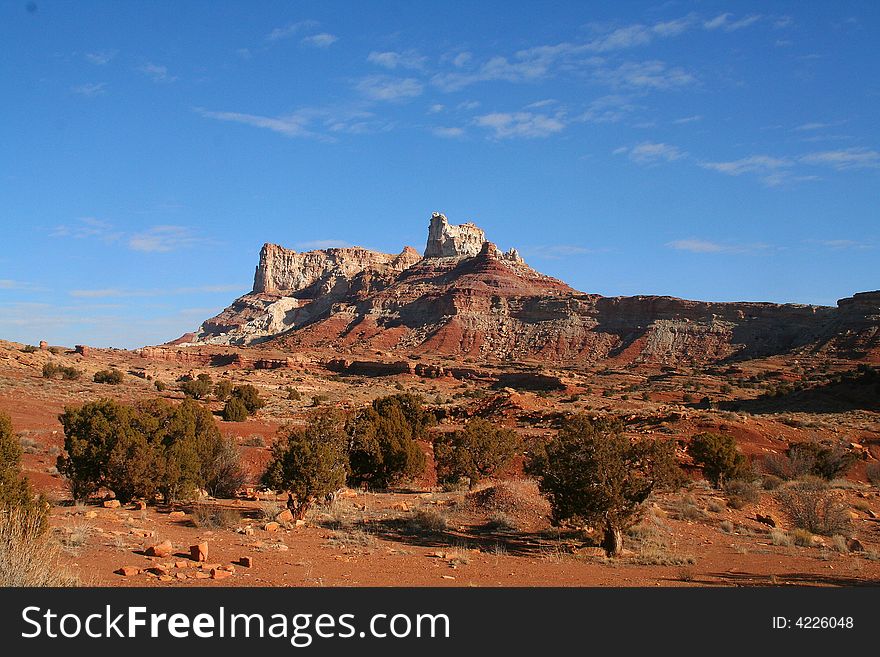 View of the red rock formations in Canyonlands National Park with blue skyï¿½s and clouds. View of the red rock formations in Canyonlands National Park with blue skyï¿½s and clouds