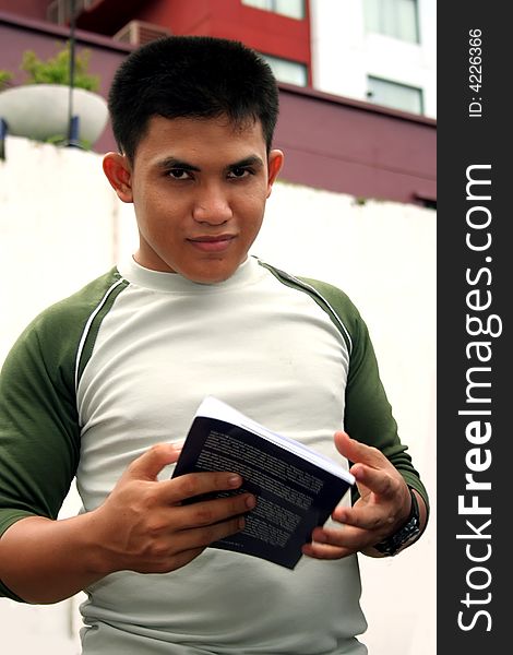 Photograph of student holding book