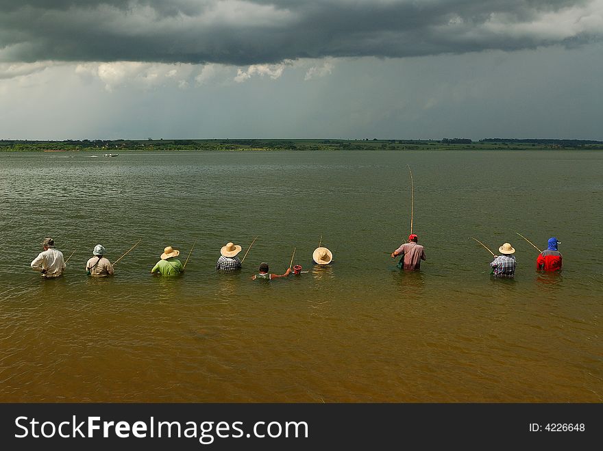 A group of fishermen on the river