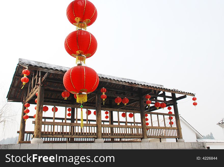 Red latern and wood pavilion on a stone bridge,scenic in a watery town,south eastern china。