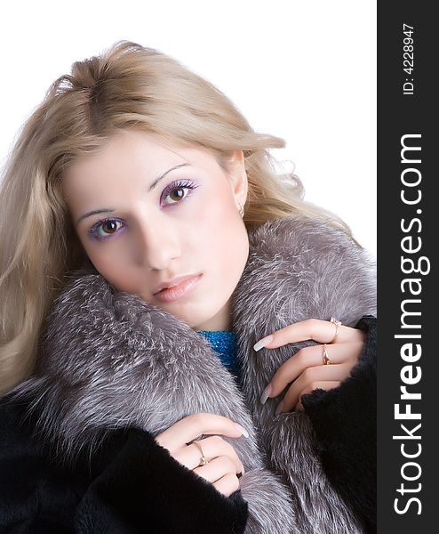 Nice girl in a fur coat isolated on a white background