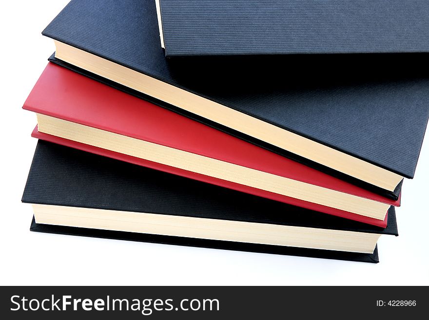 Red and black books stacked on top of eachother isolated on white background