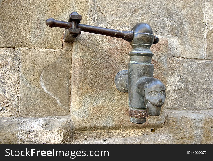 Tap on old stone wall