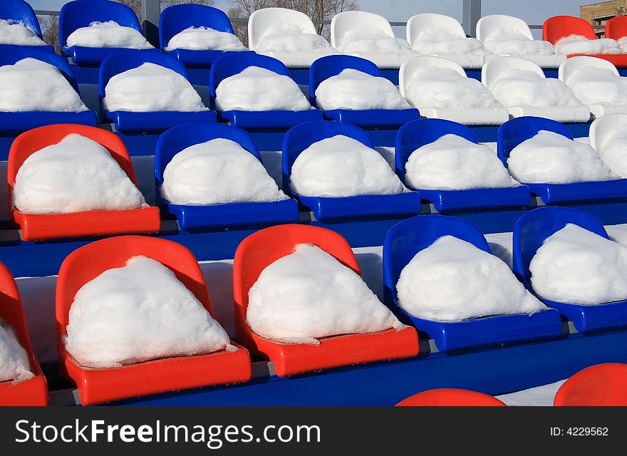 Seats on tribunes of stadium under a snow. Seats on tribunes of stadium under a snow